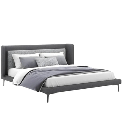 Elsa's bed features a sleek, upholstered headboard and a low-profile base.
